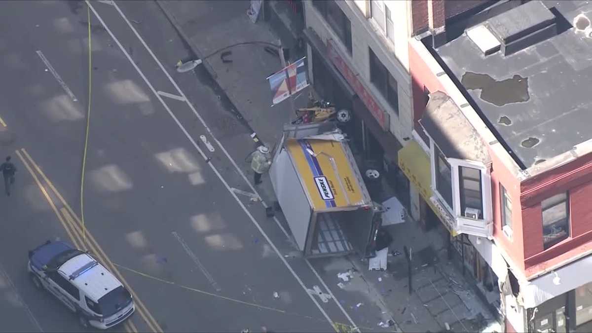 Numerous injuries from box truck flipping on Boston sidewalk.