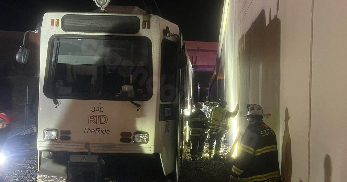 Fatal crash as vehicle falls off overpass and hits light rail train near Denver.