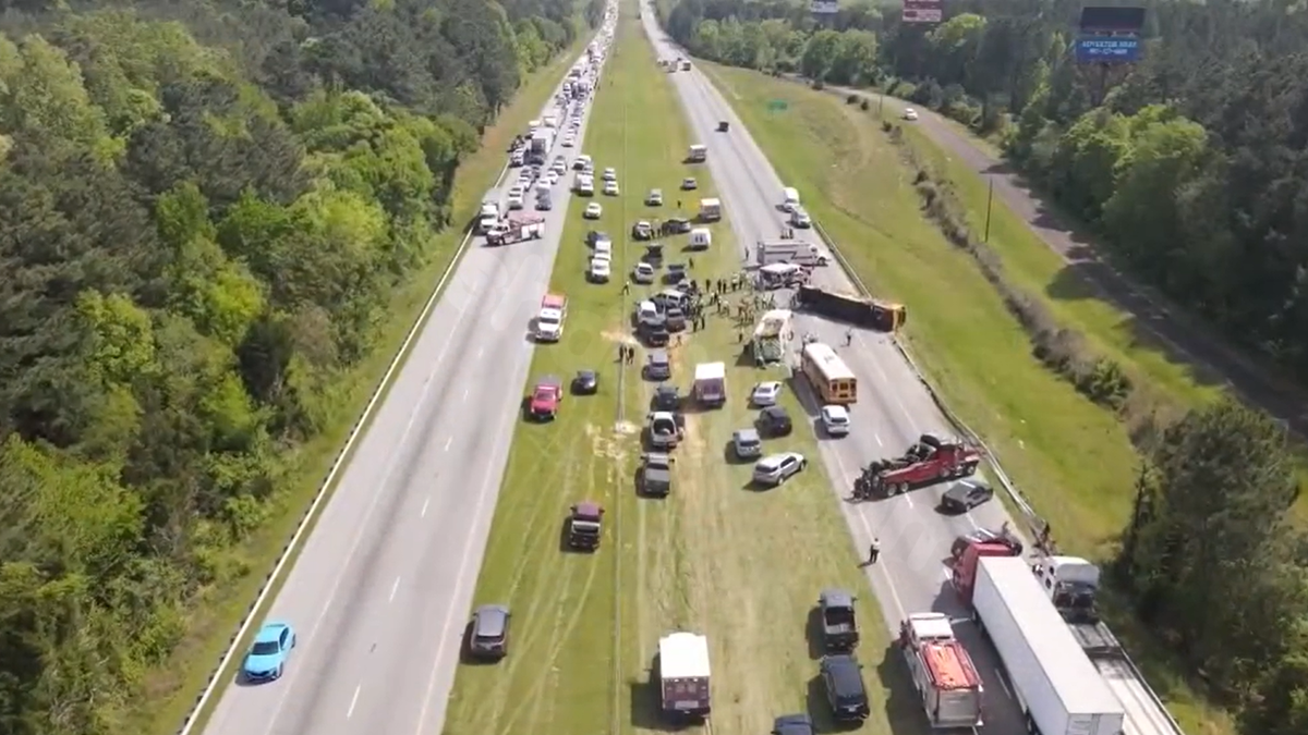 1 dead, 21 injured after school bus carrying 35 students overturns on interstate