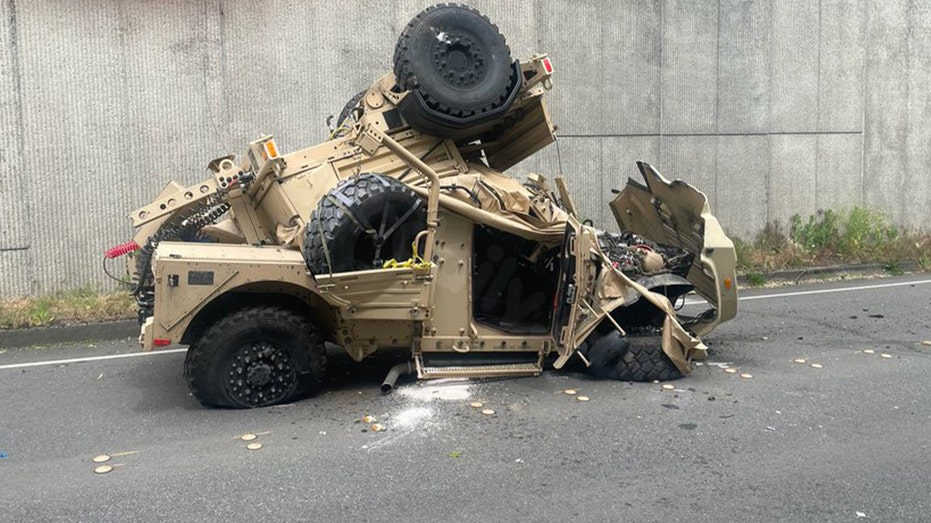 Two people hurt as military vehicle crashes over highway wall, falls 30 feet onto road
