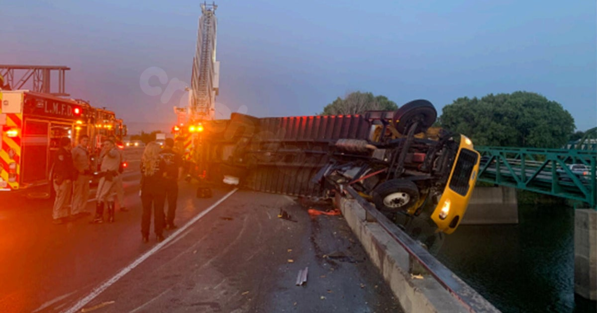 Box truck cab hangs over San Joaquin River after I-5 crash near Lathrop.