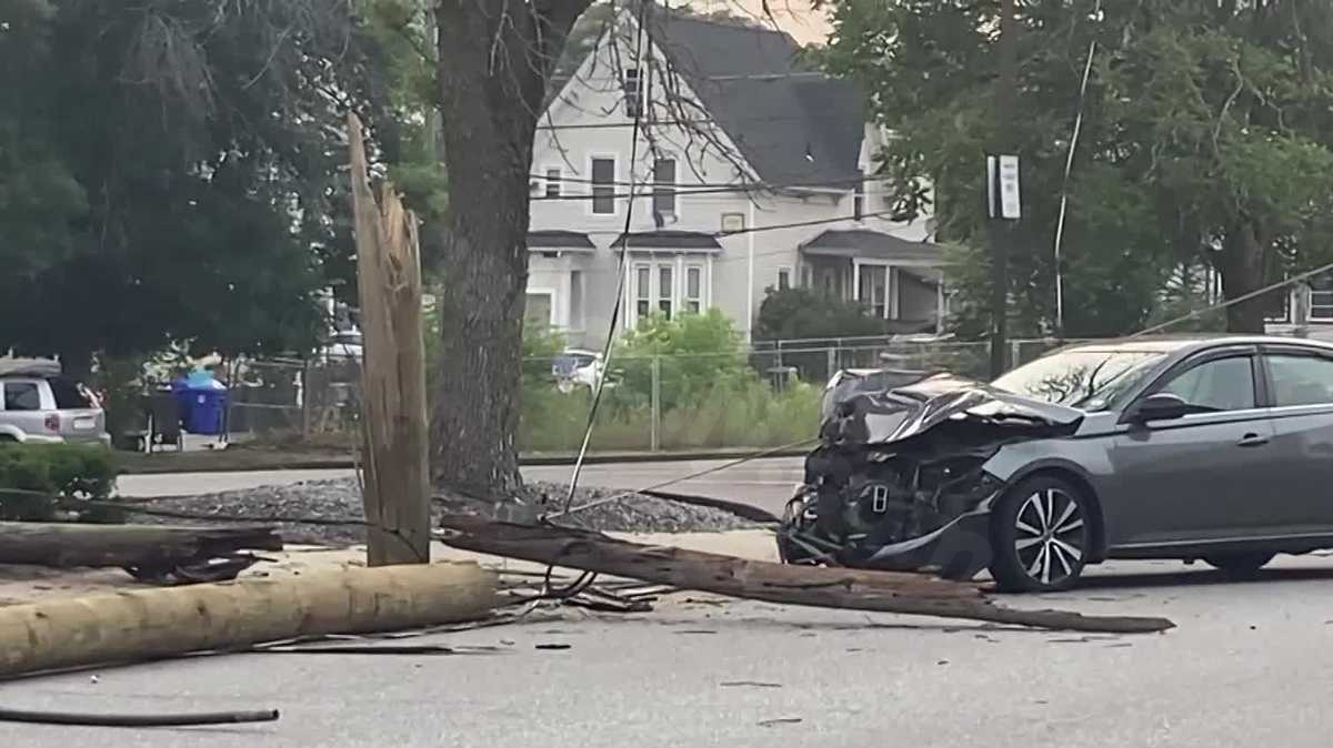 Vehicle collides with utility pole on crowded Manchester street, causing wires to fall