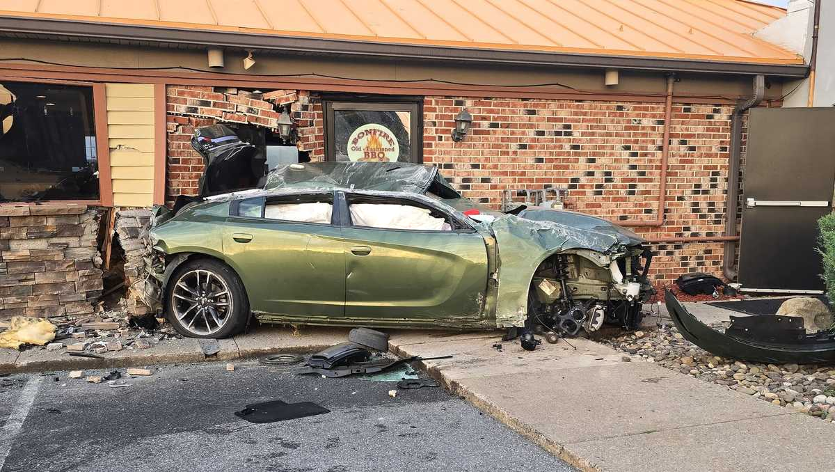 Car crashes into BBQ eatery, resulting in significant destruction.