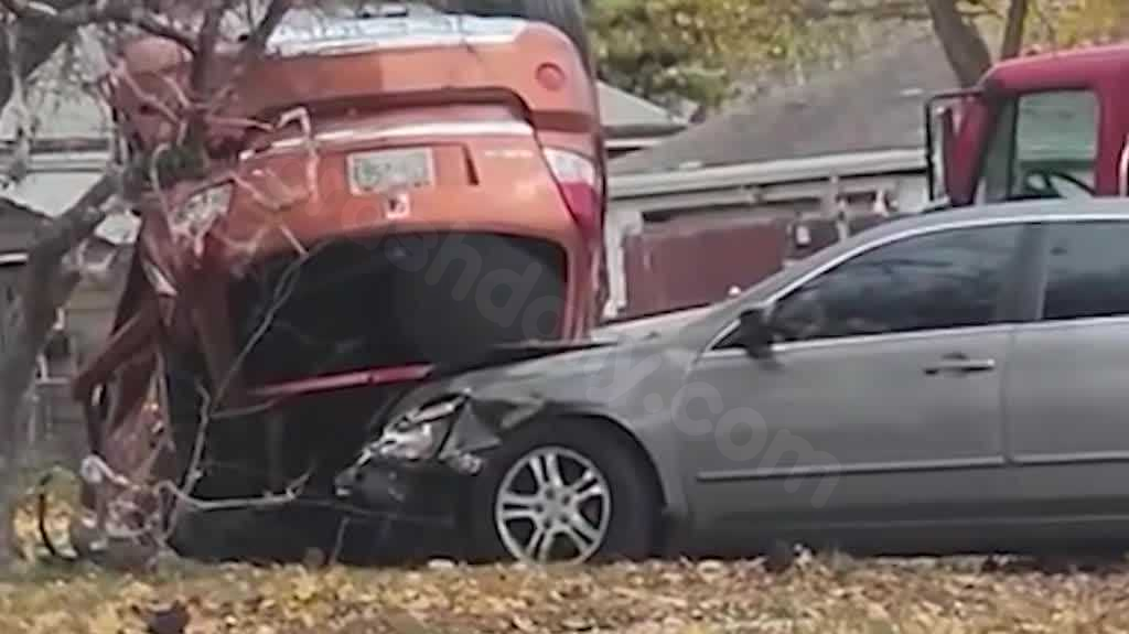 Two-vehicle collision propels cars into Milwaukee property, causing one to overturn