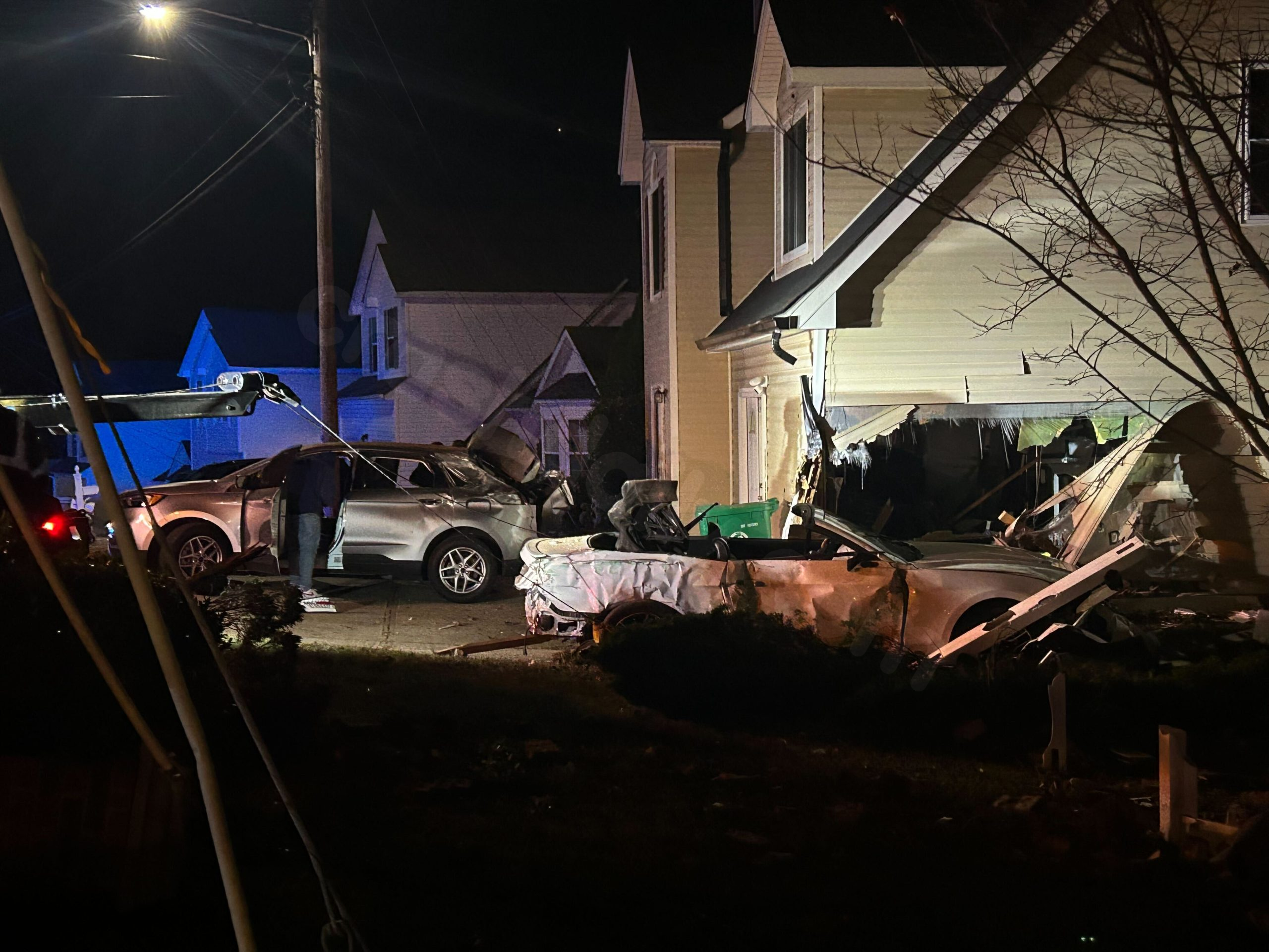 Vehicle collides with DeKalb County residence, 2 people wounded