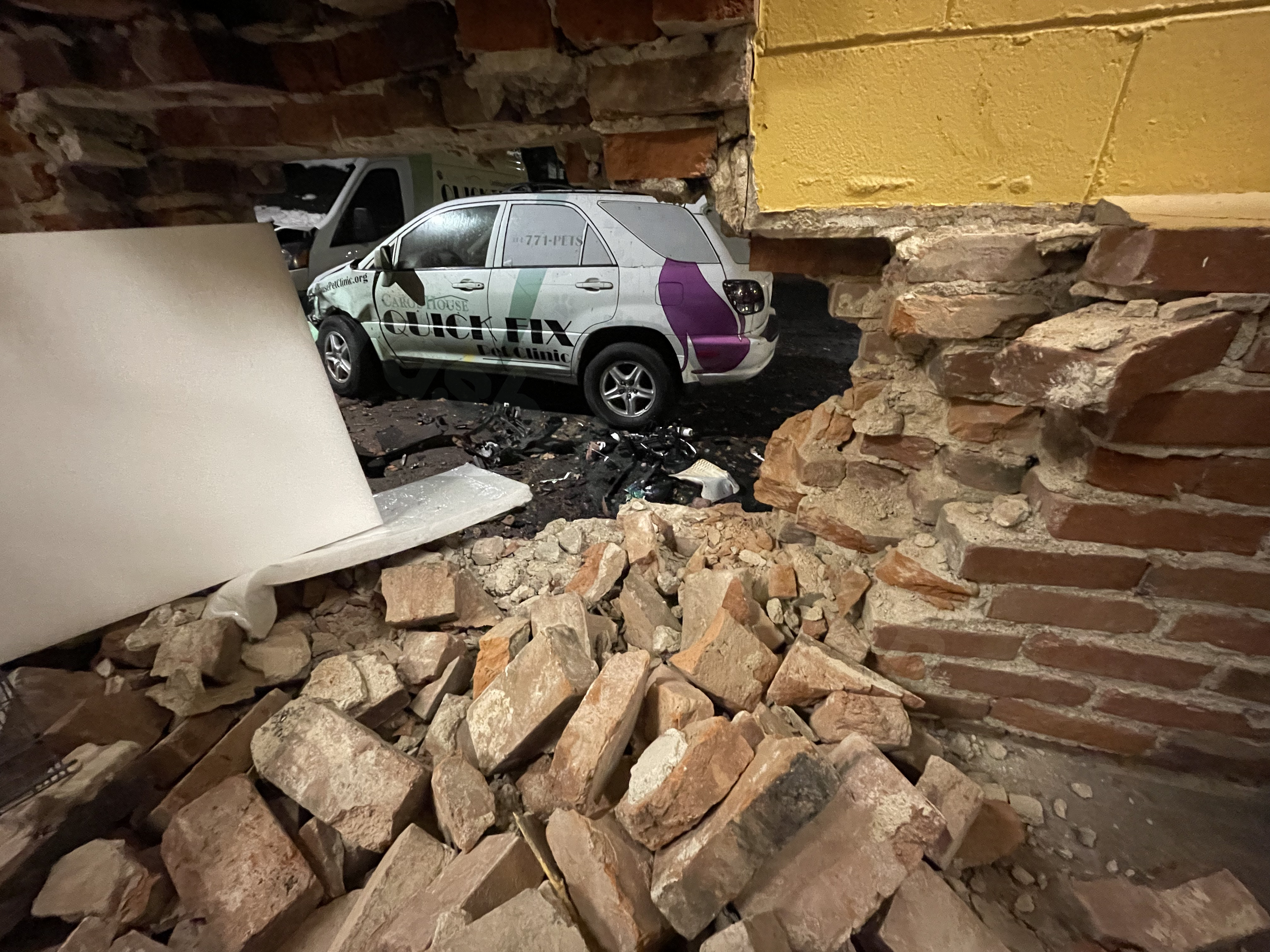 Vehicle collides with Carol House Pet Clinic, impacting three service vehicles