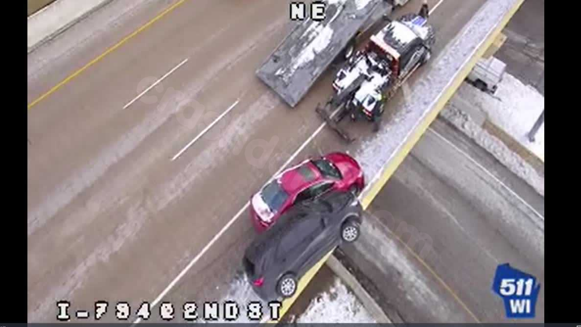Driver escapes from SUV perched on Milwaukee bridge edge after collision