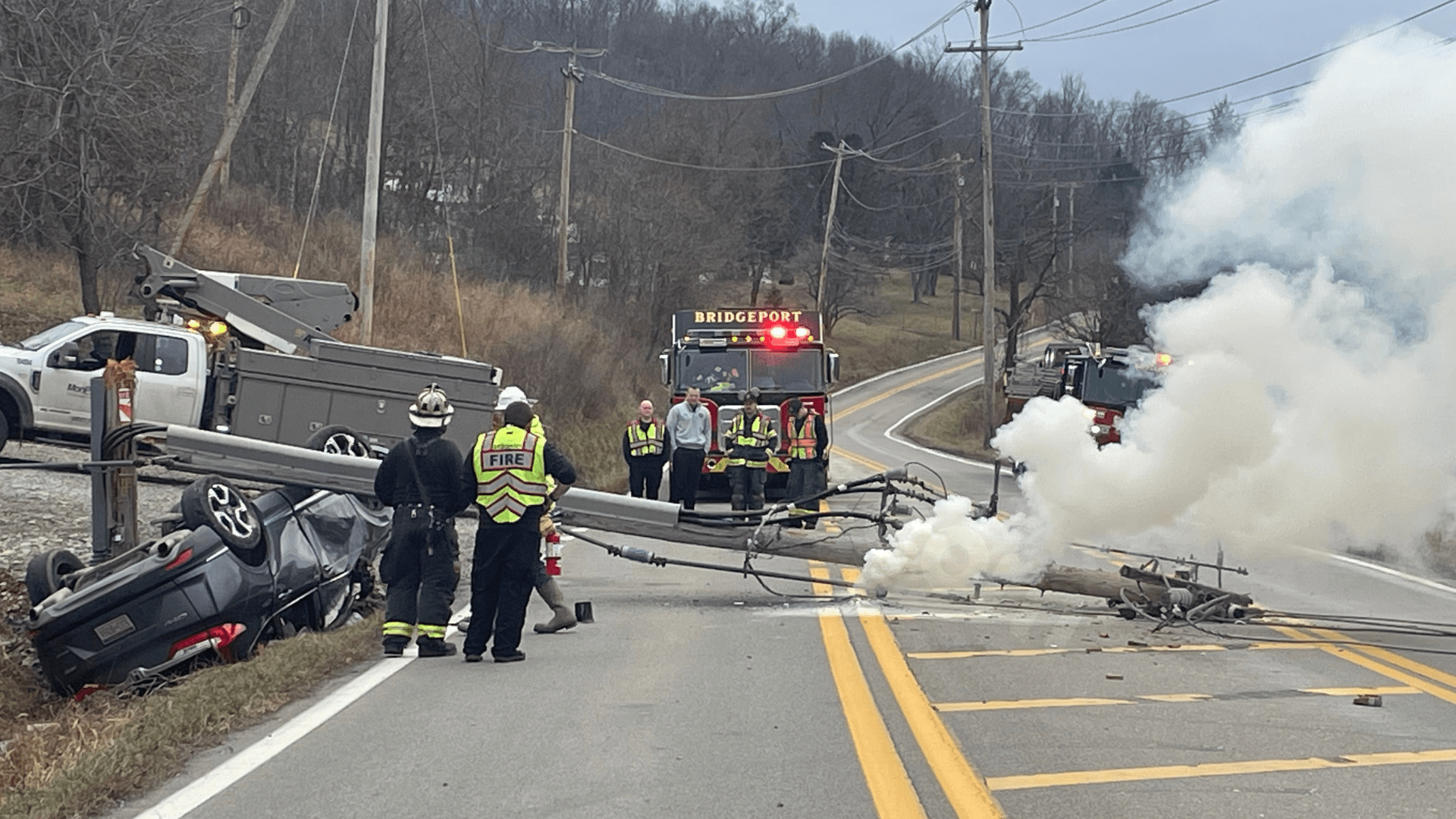 Road closure due to fire caused by vehicle accident and live wires down.