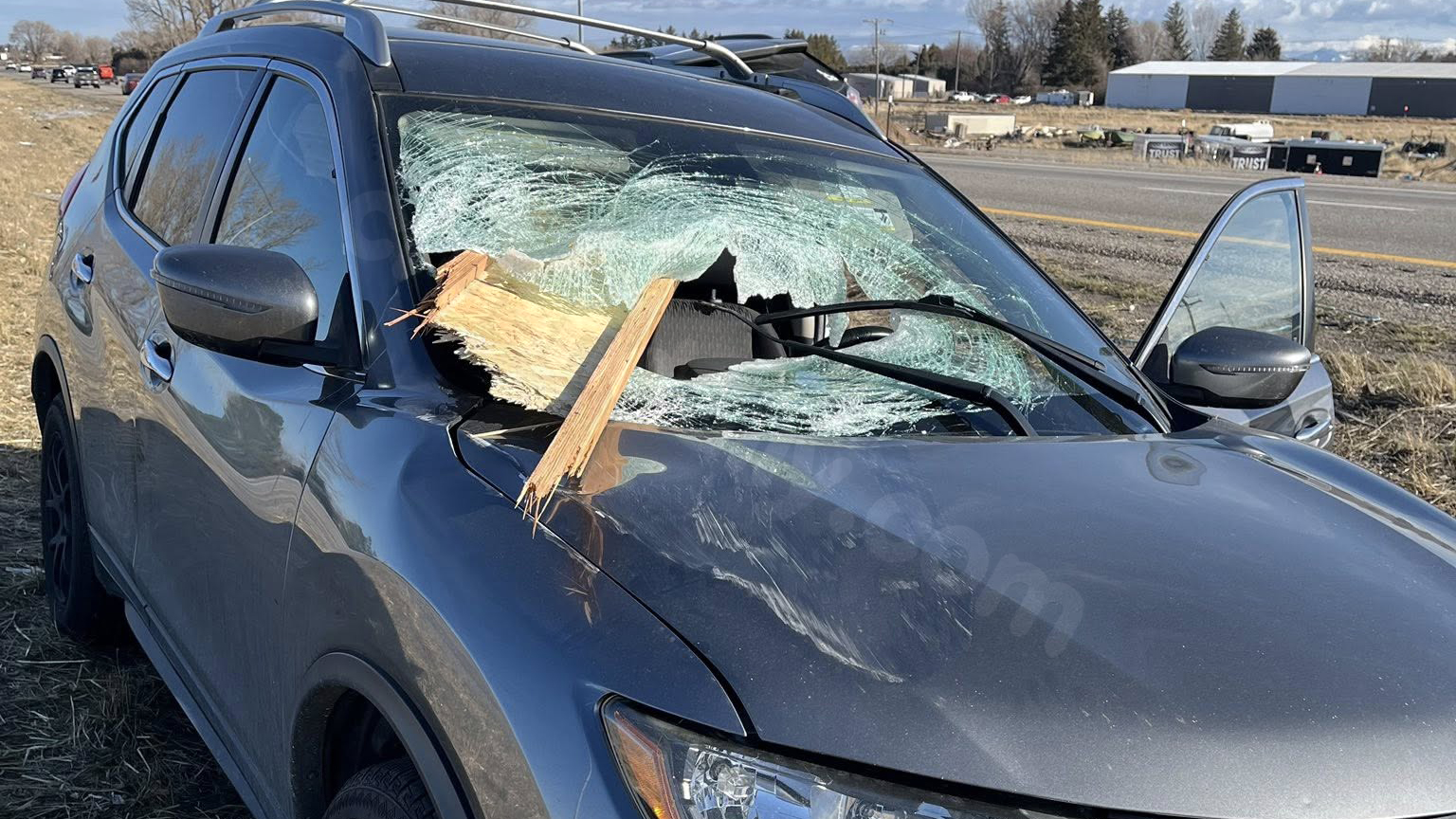 Passengers uninjured after wood smashes through car windshield