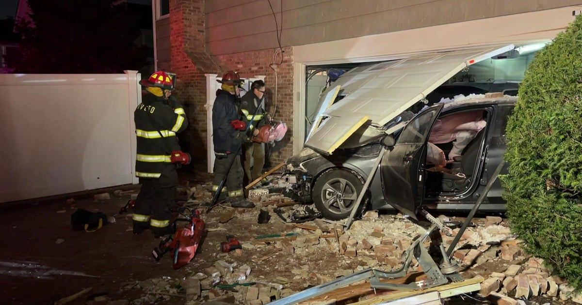 Vehicle collides with Long Island home, scattering debris