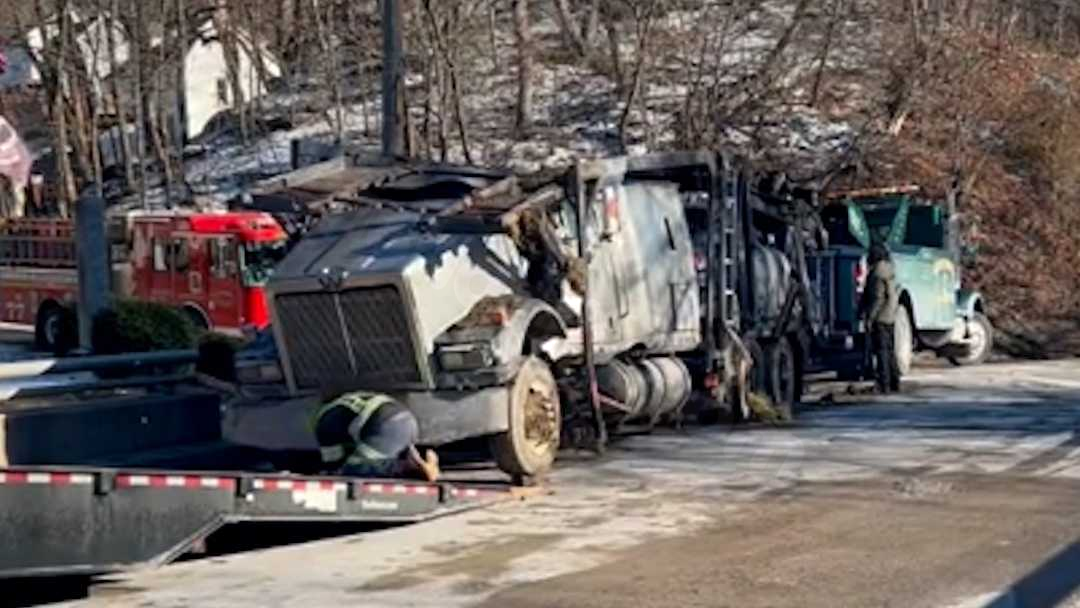 Truck carrying cars overturns, scattering vehicles | Road shut