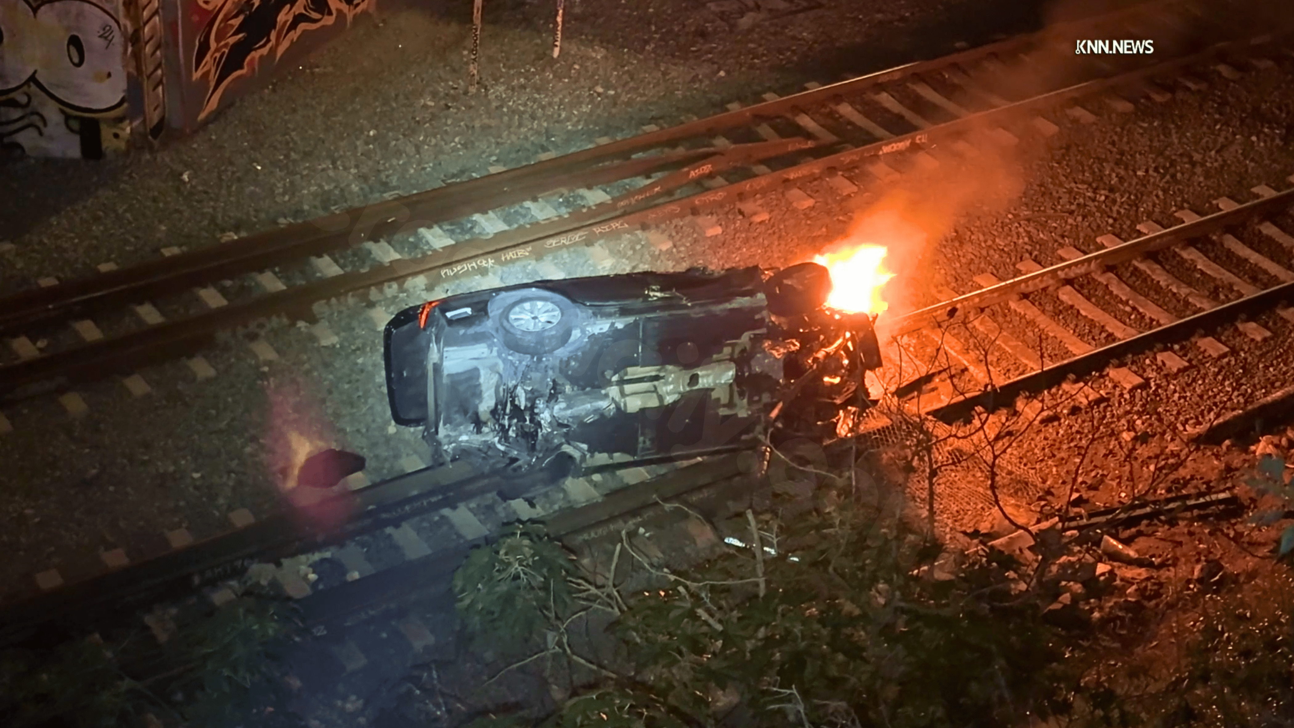 Woman survives car falling 40 feet onto LA train tracks.