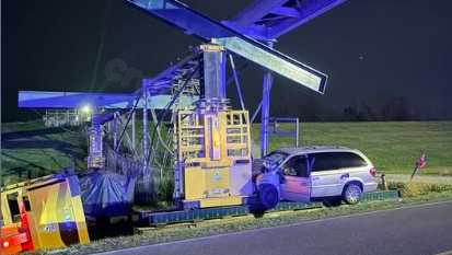 Inspecting beam post-car collision in St. John