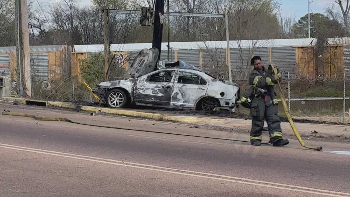 Driver burned when car crashes into bridge and bursts into flames