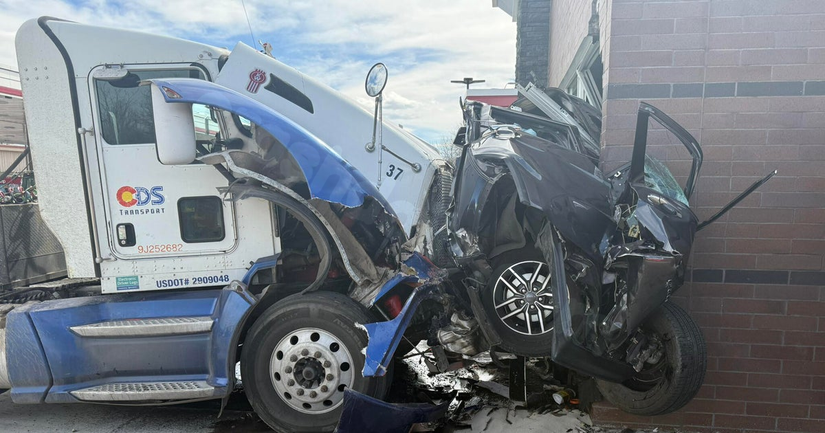 Vehicle crushed in crash with semi at QuikTrip in Denver metro area
