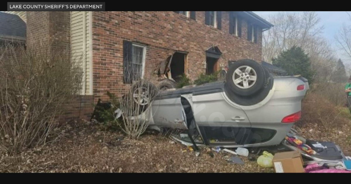 Car crashes into house and flips near Crown Point, Indiana