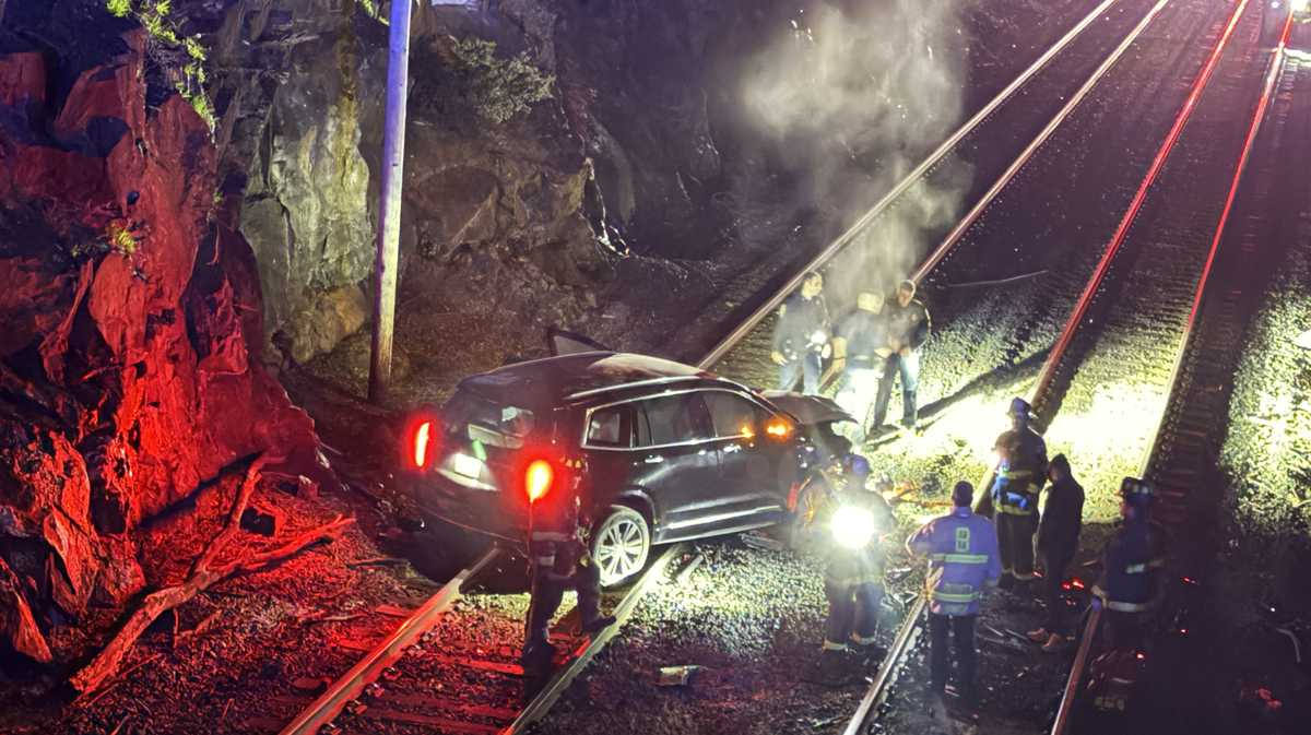 Driver crashes SUV through fence; Vehicle drops onto MBTA tracks