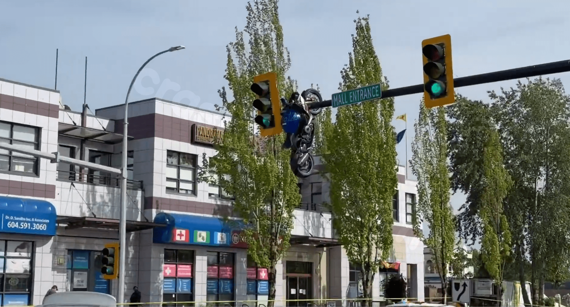 Shocking video shows motorcycle hanging off traffic light after crash