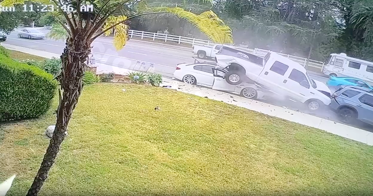 Surveillance camera captures moments car crashes underneath pickup truck in Canoga Park
