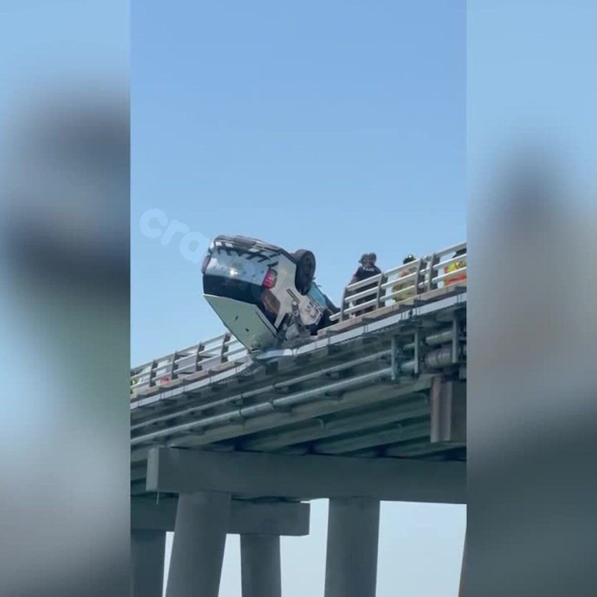 Police vehicle flips over guardrail on Chesapeake Bay Bridge-Tunnel, hangs off side