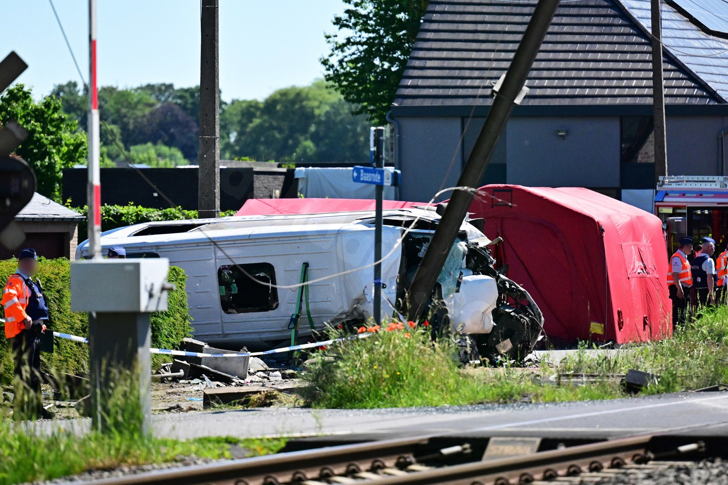 Train collides with school bus, killing 4 in Belgium