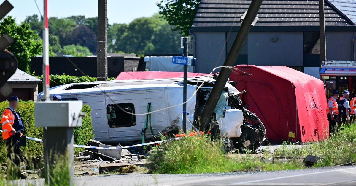 Train crashes into school minibus in Belgium, with unconfirmed reports of fatalities