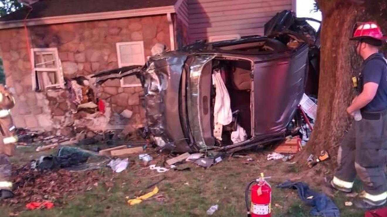 PHOTOS | 1 person hospitalized after car flips into tree, crashes into house: dispatch