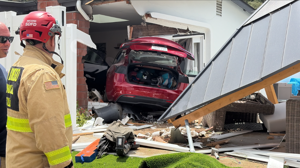 Tesla smashes through fence into Clairemont home after striking vehicle at intersection