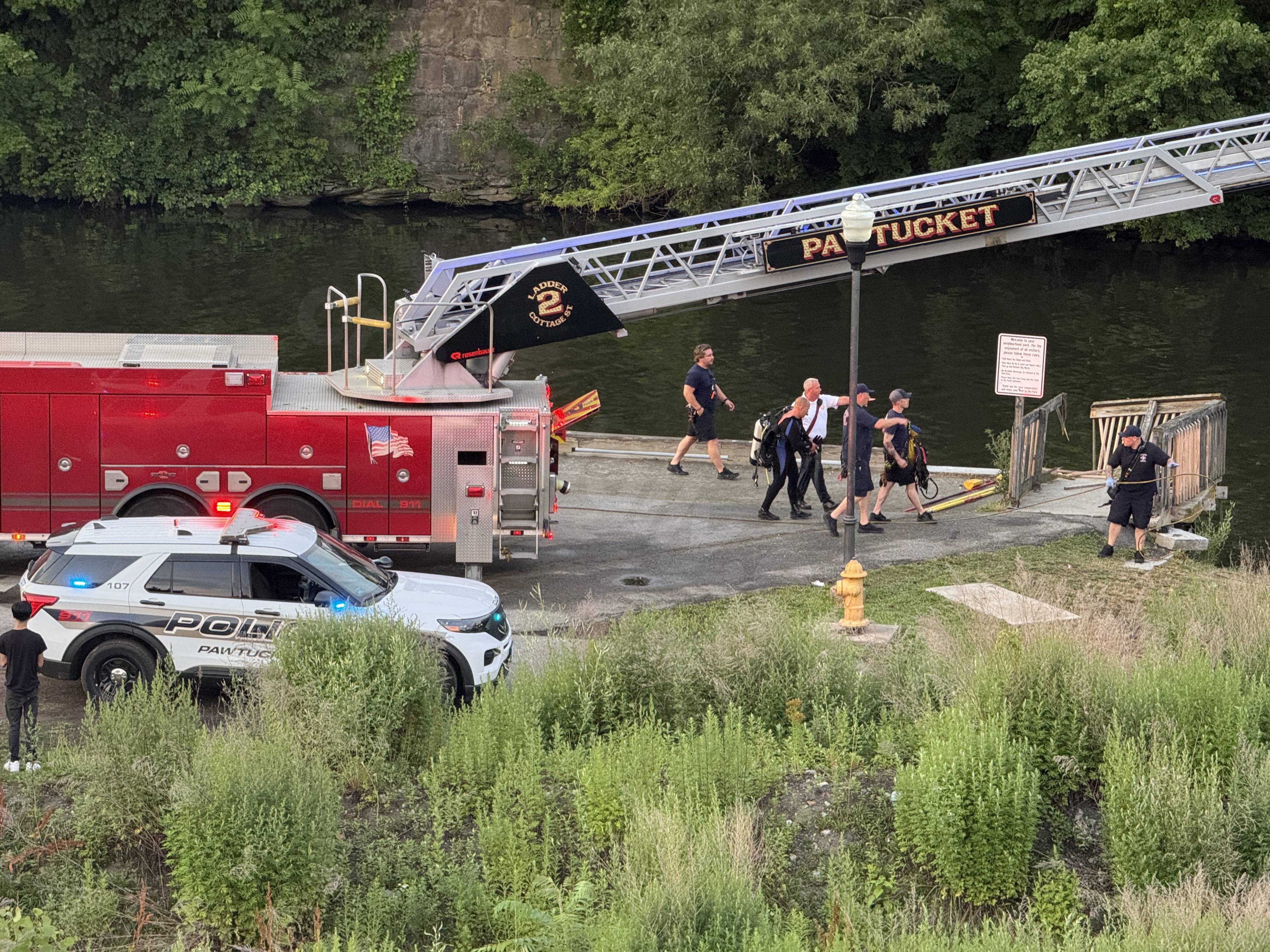 Car crashes into Pawtucket river, people trapped inside