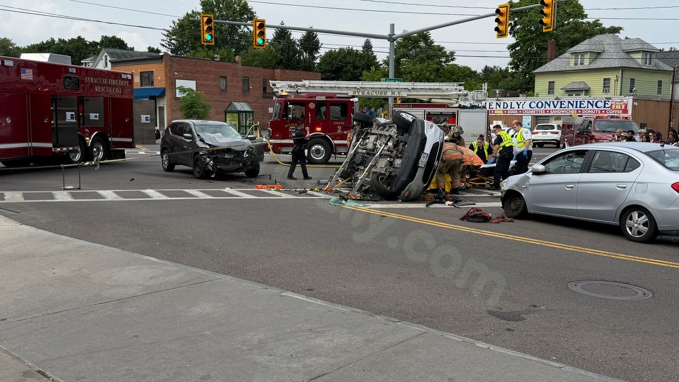 Major car accident in Syracuse; car lands on its side as driver is pulled out