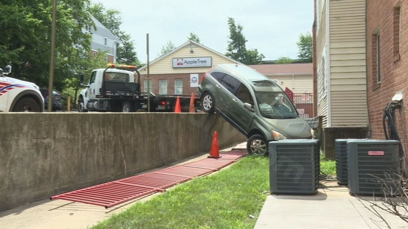 Occupants flee after vehicle crashes, left in midair near DC school