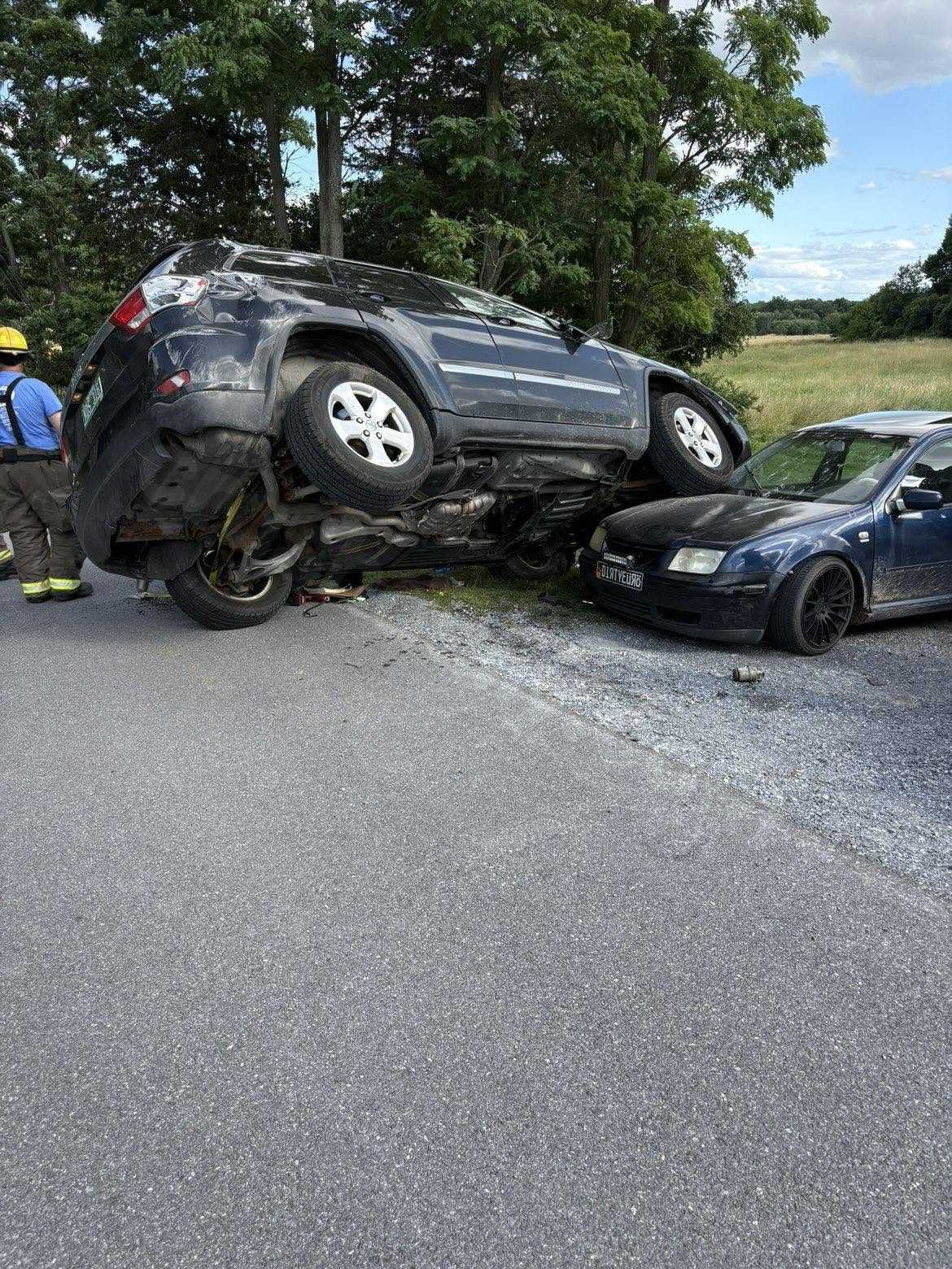 Driver hits utility pole, lands on top of parked car in Addison County