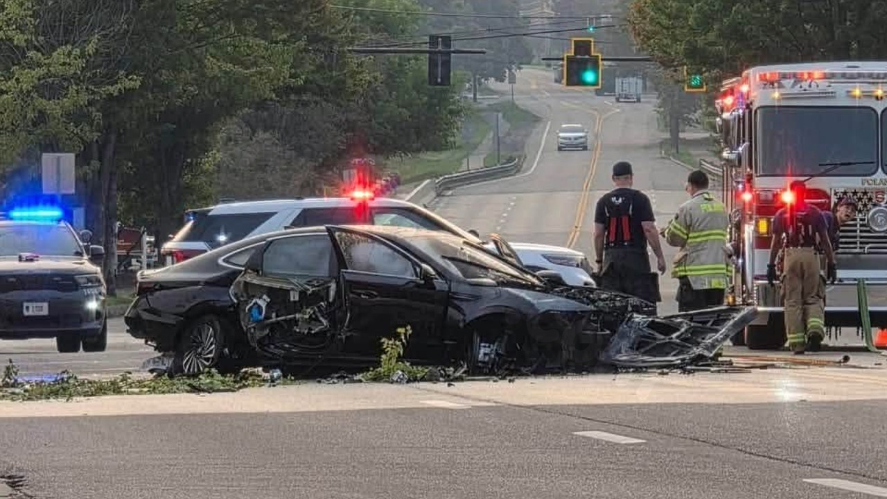 Car crashes into parking lot, catches fire